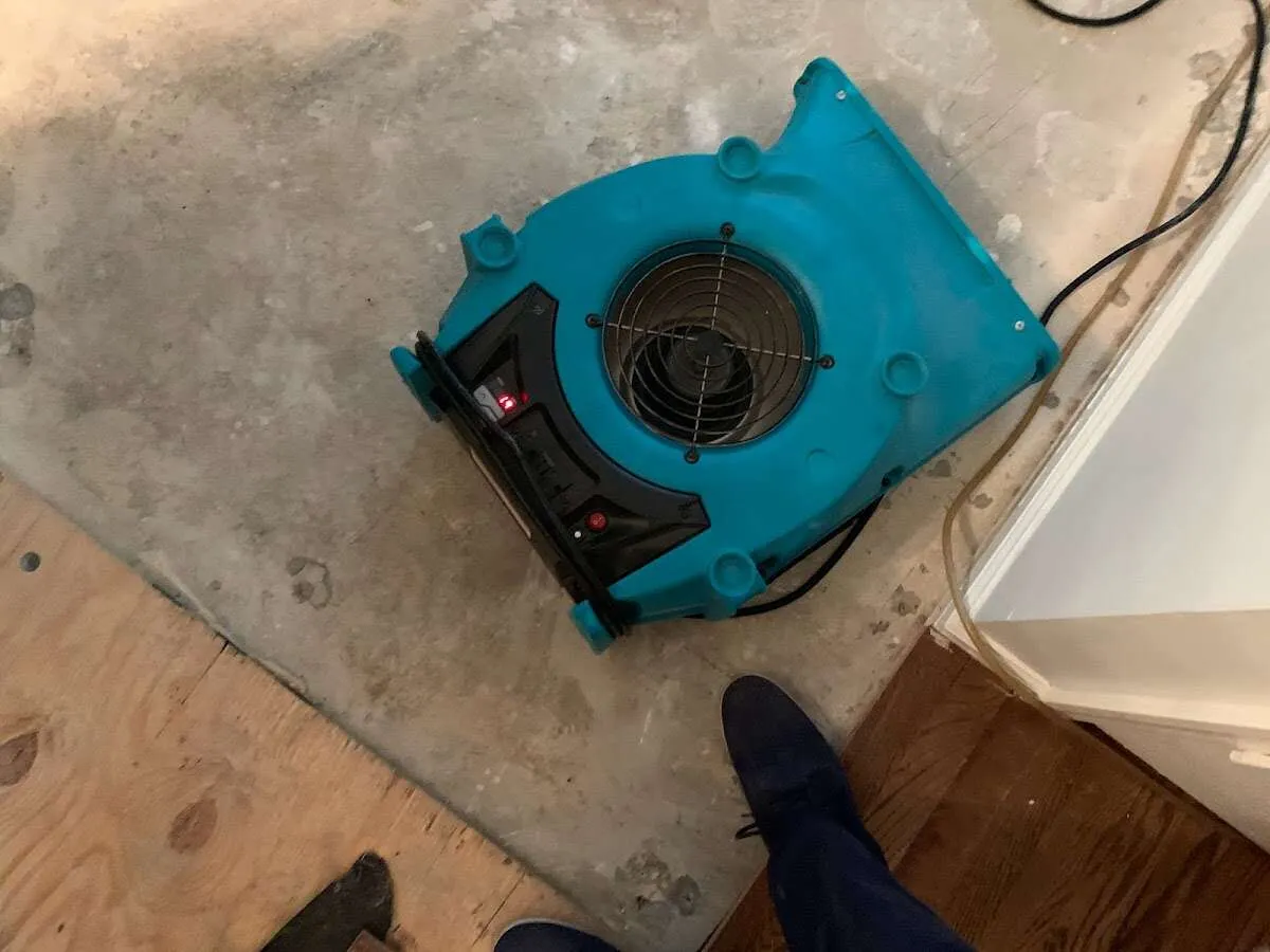 Air mover drying subfloor during Leak Detection & Repair in Lake Monticello